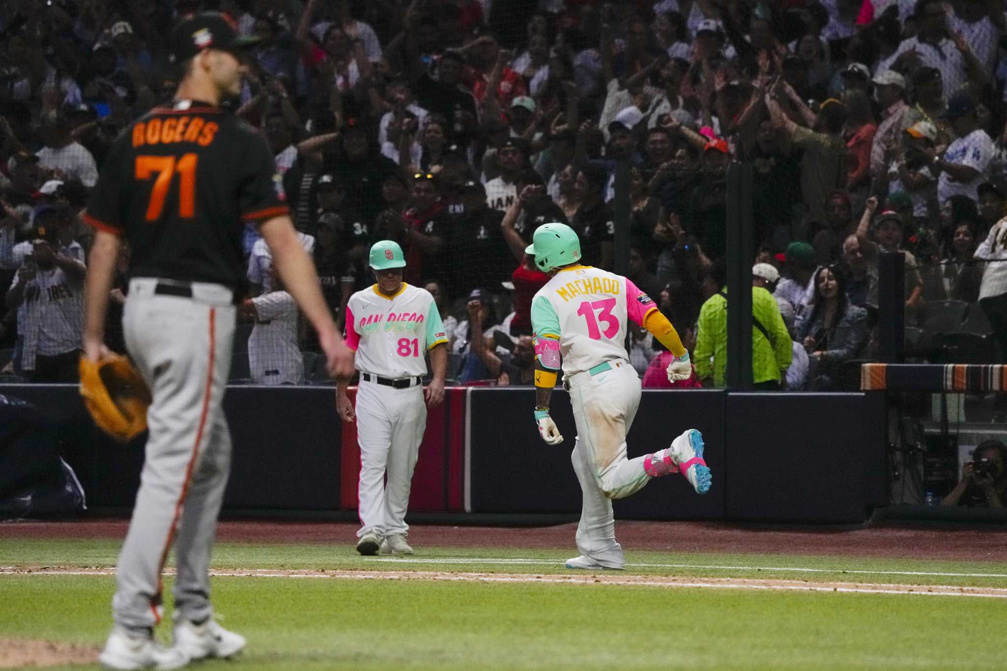 San Diego Padres third basemen Manny Machado (13) ties his shoes