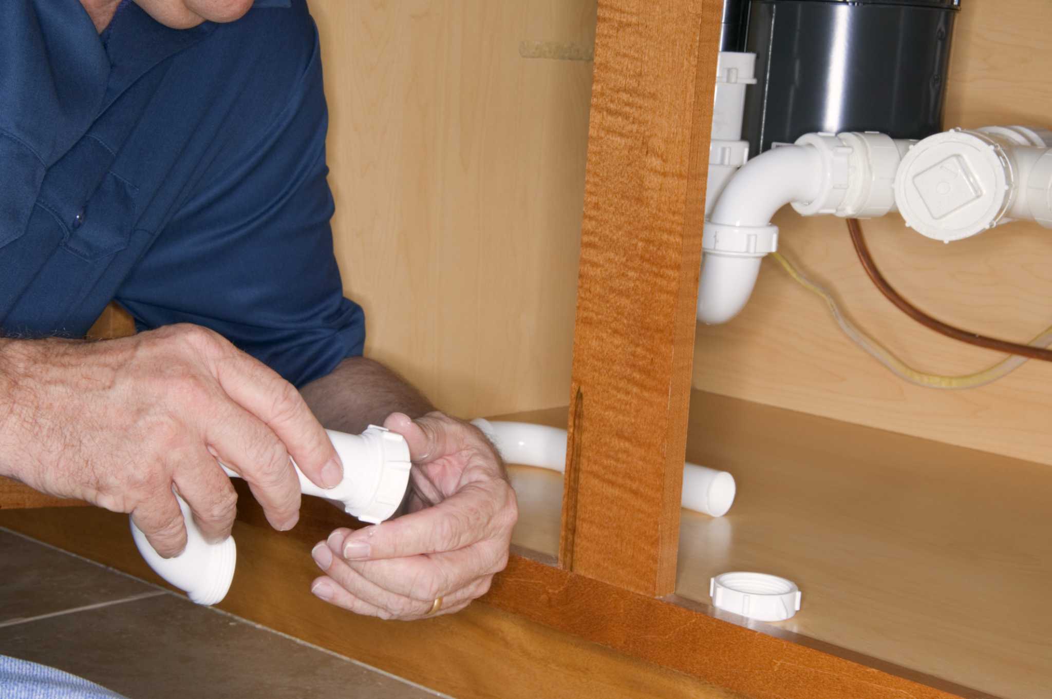 How to Change Metal Pipes to Plastic Under the Kitchen Sink