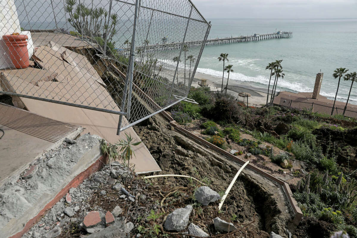 A landslide damaged the historic Casa Romantica Cultural Center and Gardens and sent dirt and debris cascading down a hillside toward coastal railroad tracks on Friday, April 28, 2023, in San Clemente.