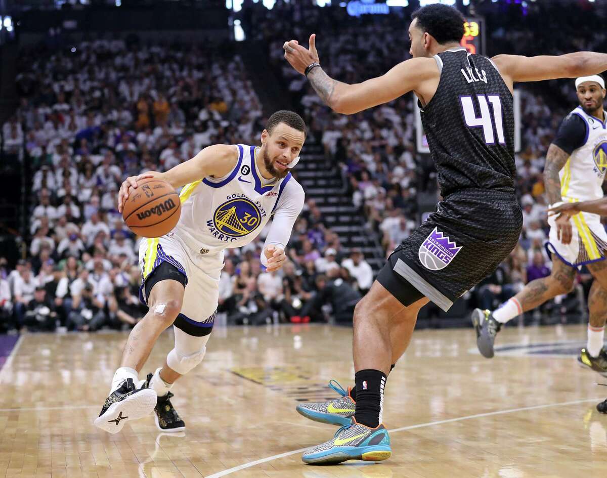 Warriors guard Stephen Curry drives against the Kings’ Trey Lyles during the first quarter of Game 7 of a first-round series at Golden 1 Center in Sacramento on Sunday.
