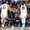 Golden State Warriors’ Stephen Curry and Draymond Green celebrate a 4-point play by Klay Thompson against Sacramento Kings during 3rd quarter of Game 7 of NBA Western Conference 1st Round Playoffs at Golden 1 Center in Sacramento, Calif., on Sunday, April 30, 2023.