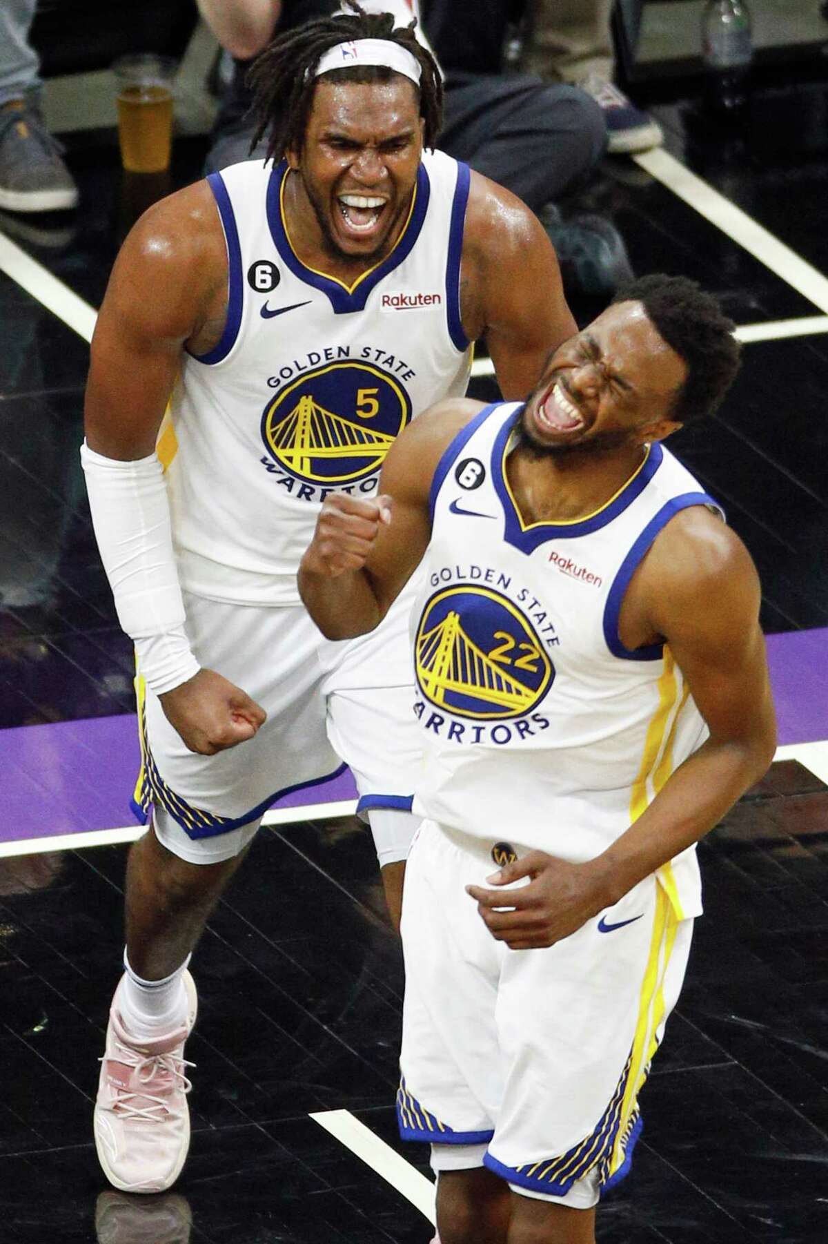 Warriors center Kevon Looney (left) and forward Andrew Wiggins have plenty to celebrate during the third quarter.