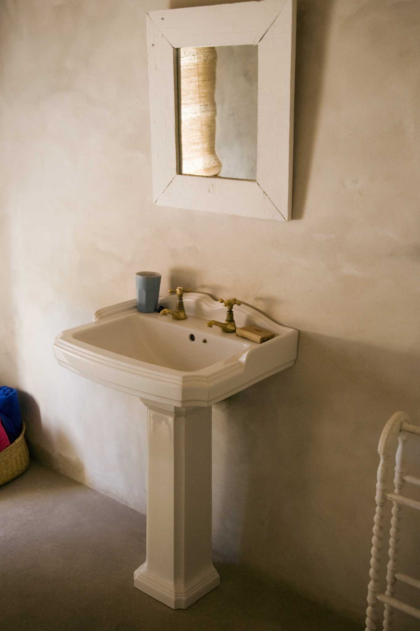 How to Attach a Pedestal Sink to the Wall Without Studs