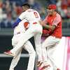 Philadelphia Phillies' Aaron Altherr, left, celebrates with teammates after hitting a game-winning two-run double off St. Louis Cardinals relief pitcher Matt Bowman during the 10th inning of a baseball game, Monday, June 18, 2018, in Philadelphia. Philadelphia won 6-5.