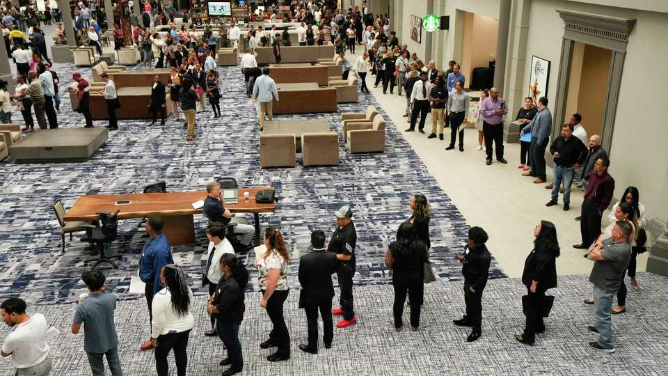 Job seekers line up to attend a United Airlines job fair on Thursday, May 4, 2023 in Houston. There were 8,000 people registered to attend the job fair, as the airline looks to fill 2100 positions in the Houston market this year. Worldwide United is seeking to fill 50,000 jobs systemwide through 2026.