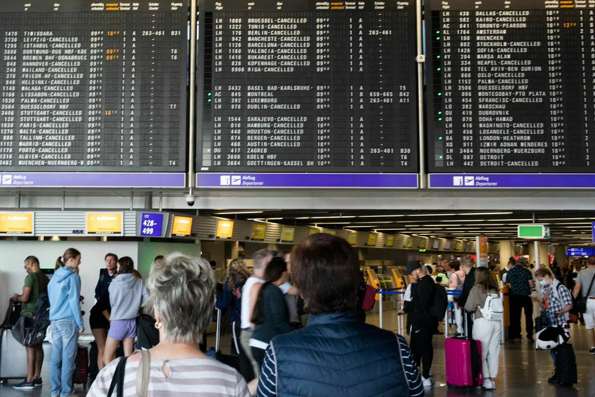 FILE: Scenes during a pilots strike as passengers wait and queue for rebooking their flight in front of a schedule board at Frankfurt Airport in Germany on Sept. 2, 2022.