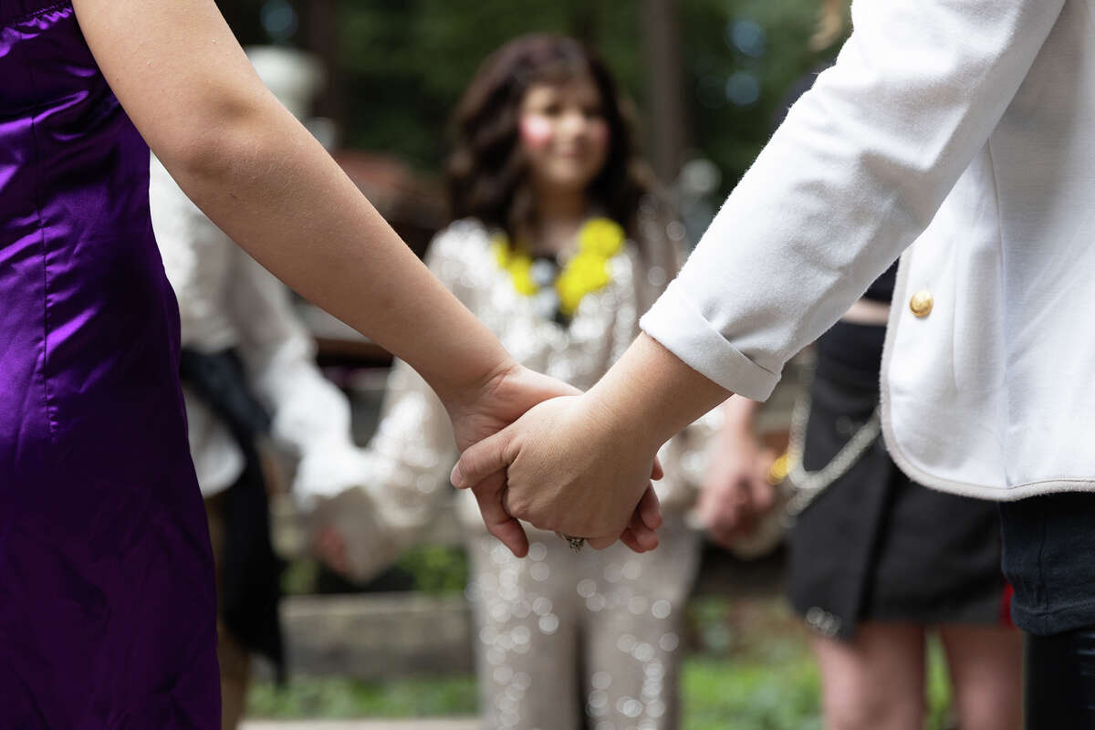 Students in “The Art of Drag” Young Actors’ Theatre Camp workshop and their instructor hold hands and discuss the safe space they’ve created over the weekend in Ben Lomond on April 2, 2023. 