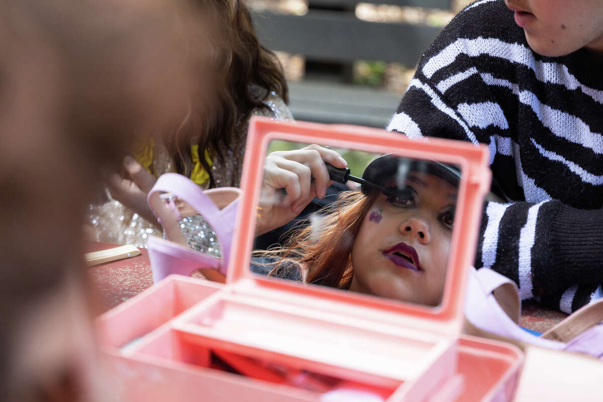 "The Art of Drag" workshop participant Cherry Bomb puts mascara on before the Youth Actor's Theatre Camp showcase in Ben Lomond on April 2, 2023. 