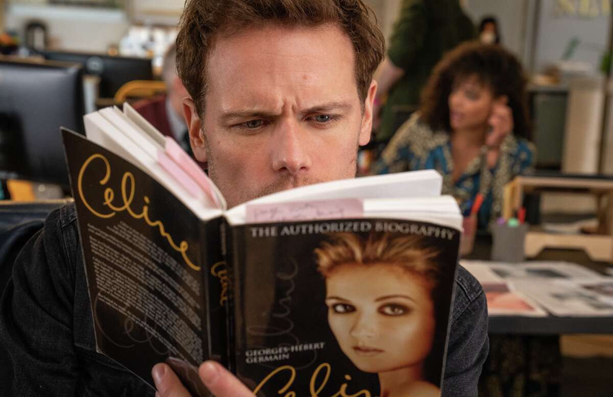 Sam Heughan reading about the world's greatest singer in Love Again
