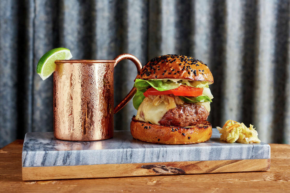 The Big Island Cheeseburger on the menu at Monkeypod Kitchen is a Big Island beef patty stacked with Dijon aioli, sauteed onions, tomato, lettuce and a pickle.