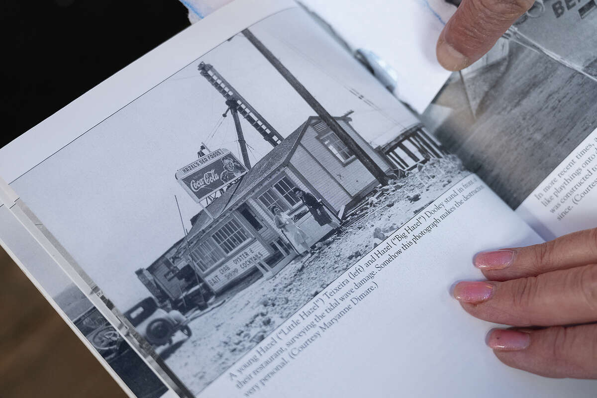 Melodie Madsen points to a historic photo of Hazel's after the tidal wave hit Princeton-by-the-Sea in 1946.