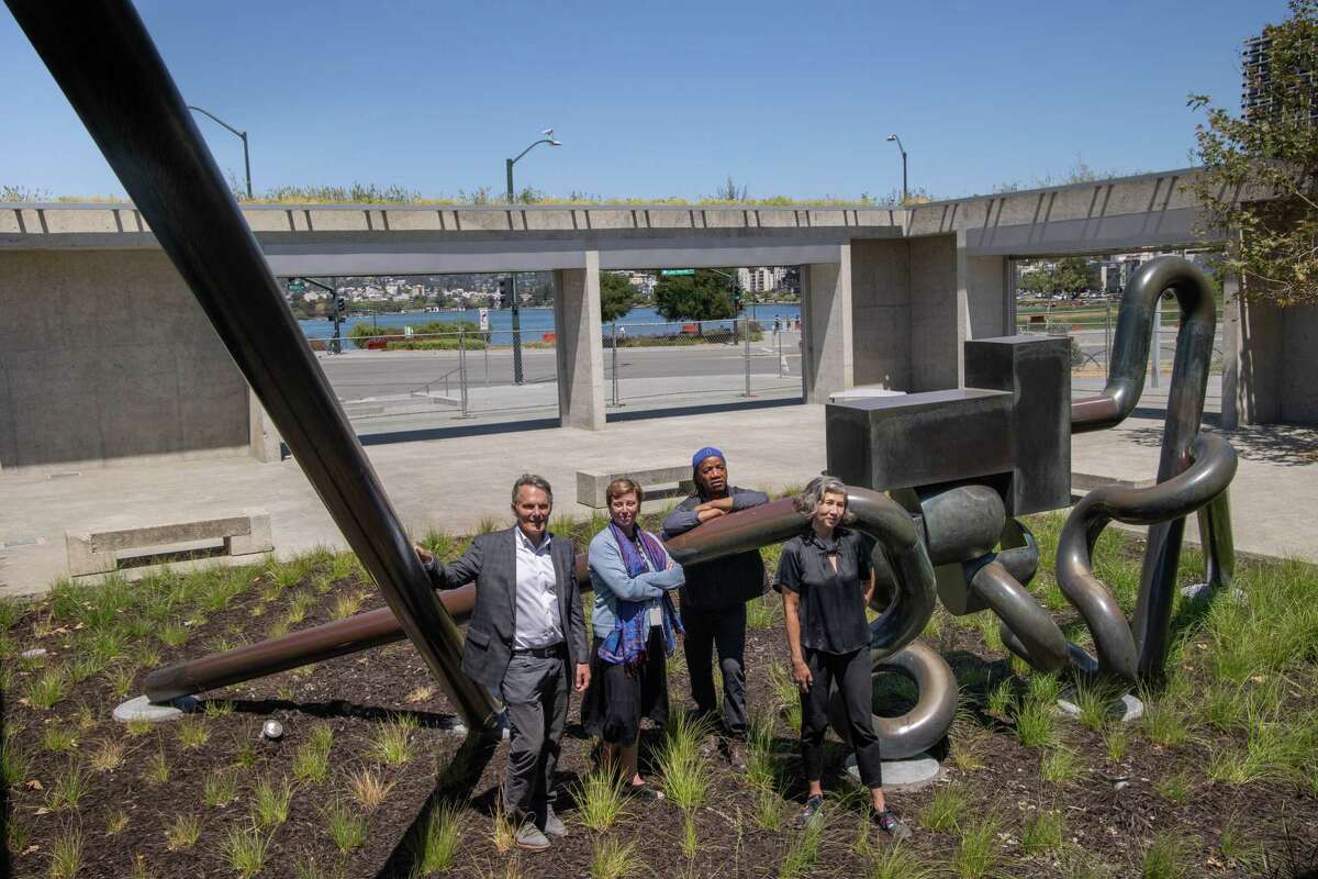 Architect Mark Cavagnero (left), Oakland Museum of California CEO Lori Fogarty, architect Walter Hood and OMCA curator Carin Adams on May 27, 2021, in front of sculpture “Mr. Ishi” in the redesigned OMCA garden and terraces.