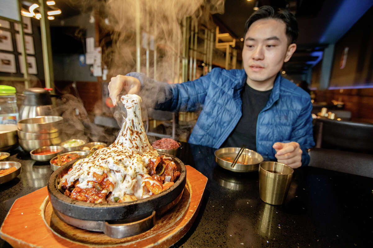 Tim Cheung of Bay Area Foodies prepares to eat a dish of Kalbijjim at Daeho Korean BBQ & Beef Soup in San Francisco, Calif. on May 9, 2023. He is a social media influencer with hundreds of thousands of followers on Instagram and TikTok.