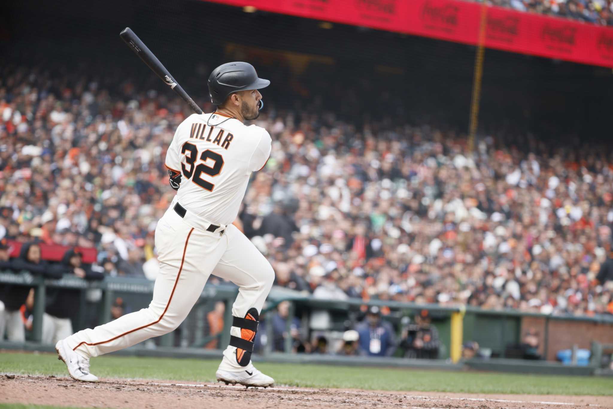 San Francisco Giants hitting coach Justin Viele sits in the dugout after a  baseball game against