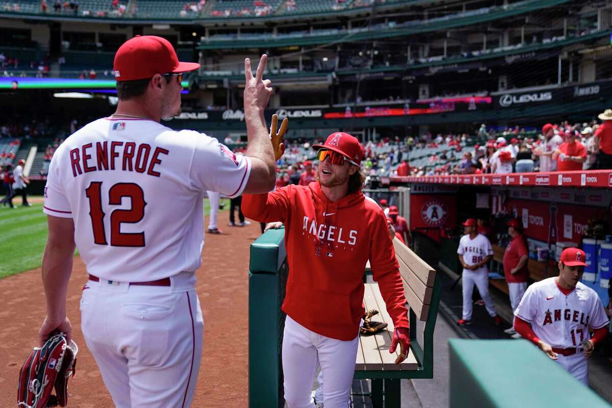 Los Angeles Angels right fielder Hunter Renfroe (12) greets center fielder Brett Phillips (8) before a baseball game against the Houston Astros in Anaheim, Calif., Wednesday, May 10, 2023.