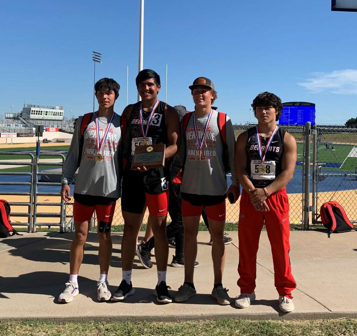 The Garden City boys 1,600 relay team poses with its medals and hardware after it won the Region II-1A title, April 29 at San Angelo's LeGrand Stadium. 