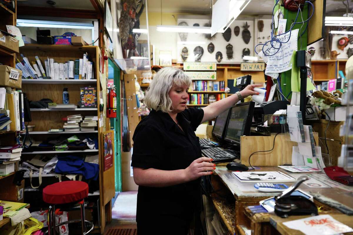 Store manager Eileen McCormick helps a customer at Green Apple Books in San Francisco.  Amazon's sponsorship of San Francisco's Small Business Week is 