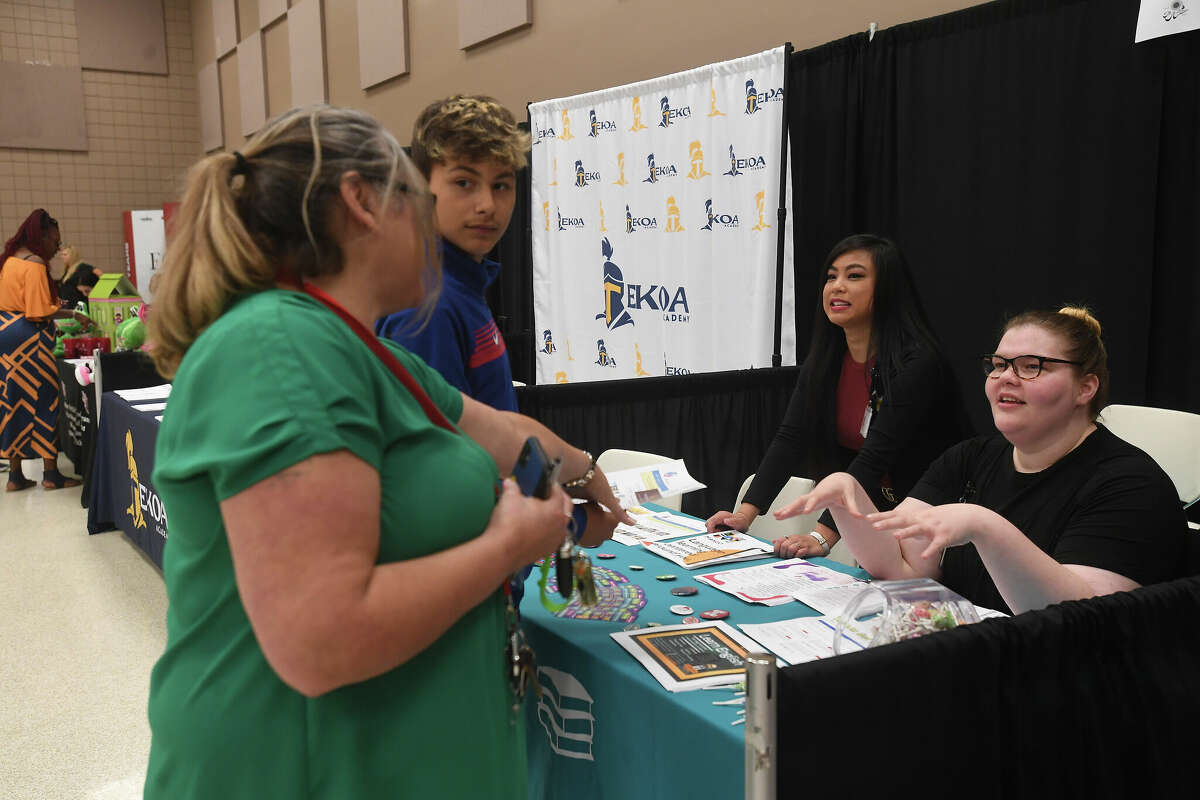 Severa McGrady and her grandson Isaah Mesa talk with Port Arthur Library's Linda Nguyen and Rachel Scott at the Spring Job Fair hosted by Workforce Solutions at the Bob A. Bowers Civic Center in Port Arthur. Photo made Thursday, May 11, 2023 Kim Brent/Beaumont Enterprise