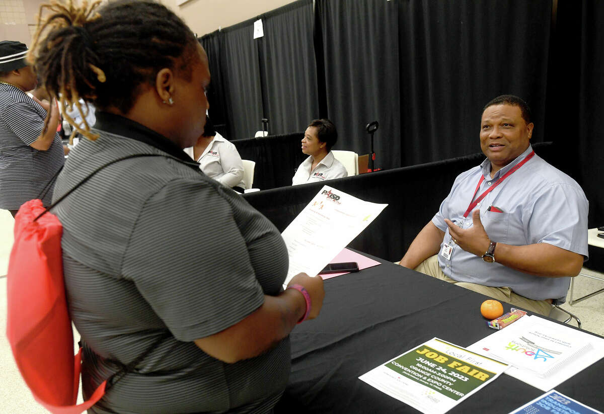 Port Arthur schools Director of Maintenance and Custodial Edgar Redeaux talks with Tianna Lee at the Spring Job Fair hosted by Workforce Solutions at the Bob A. Bowers Civic Center in Port Arthur. Photo made Thursday, May 11, 2023 Kim Brent/Beaumont Enterprise
