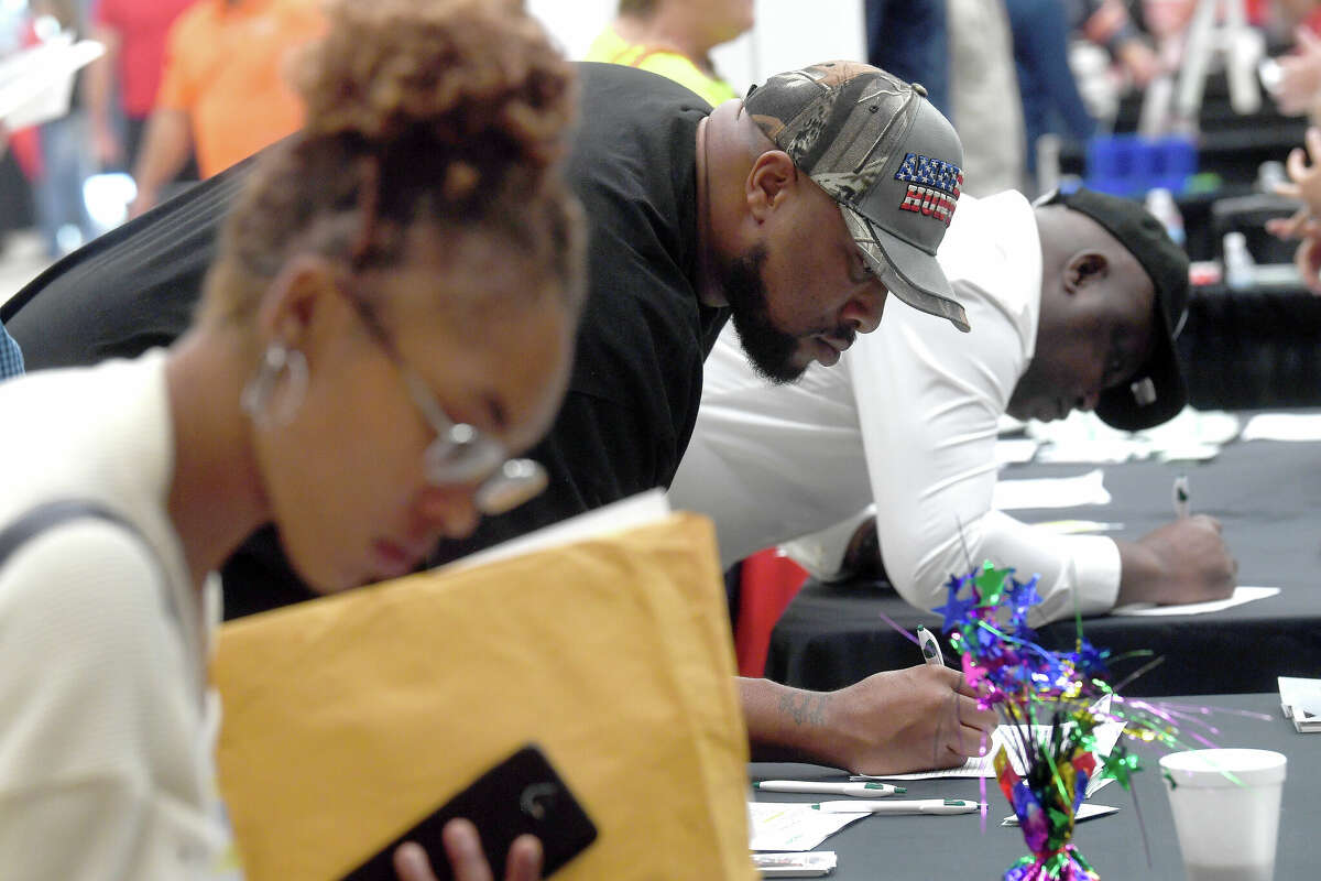 Job seekers fill out applications at the Spring Job Fair hosted by Workforce Solutions at the Bob A. Bowers Civic Center in Port Arthur. Photo made Thursday, May 11, 2023 Kim Brent/Beaumont Enterprise
