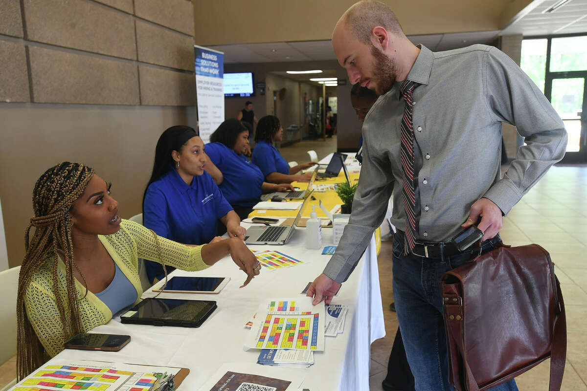 Workforce Solutions' Chasity Bill checks in job seekers at the Spring Job Fair hosted by Workforce Solutions at the Bob A. Bowers Civic Center in Port Arthur. Photo made Thursday, May 11, 2023 Kim Brent/Beaumont Enterprise