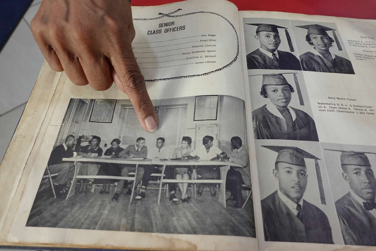 Claudia Tyler points out her uncle Don Briggs, who served as Senior Class President of Henderson High School from 1958-59. Photo taken May 11, 2023. Photo by Olivia Malick/ The Enterprise.
