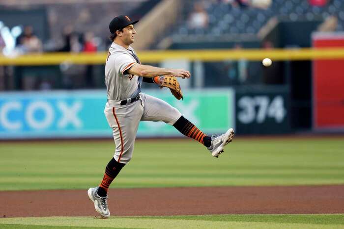 San Francisco Giants' Anthony DeSclafani runs to first base after dropping  down a bunt against the Arizona Diamondbacks during the ninth inning of a  baseball game Wednesday, May 26, 2021, in Phoenix.