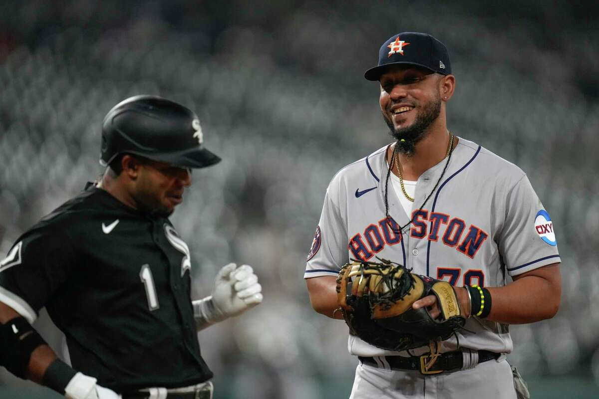 Houston Astros first baseman Jose Abreu, right, smiles as his former teammate, Chicago White Sox's Elvis Andrus, left, is out at first base during the third inning of a baseball game Friday, May 12, 2023, in Chicago.