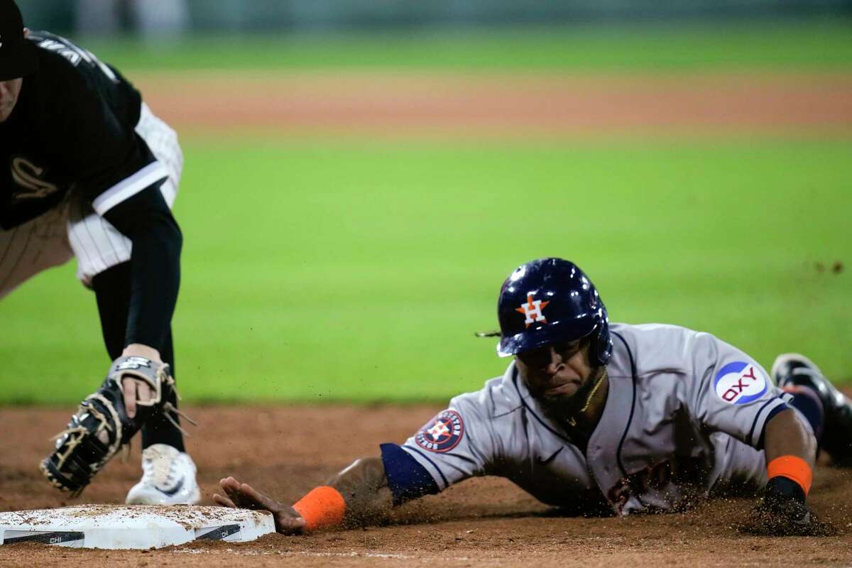 Houston Astros' Corey Julks dives safely back to first base during the fourth inning of a baseball game against the Chicago White Sox, Friday, May 12, 2023, in Chicago.