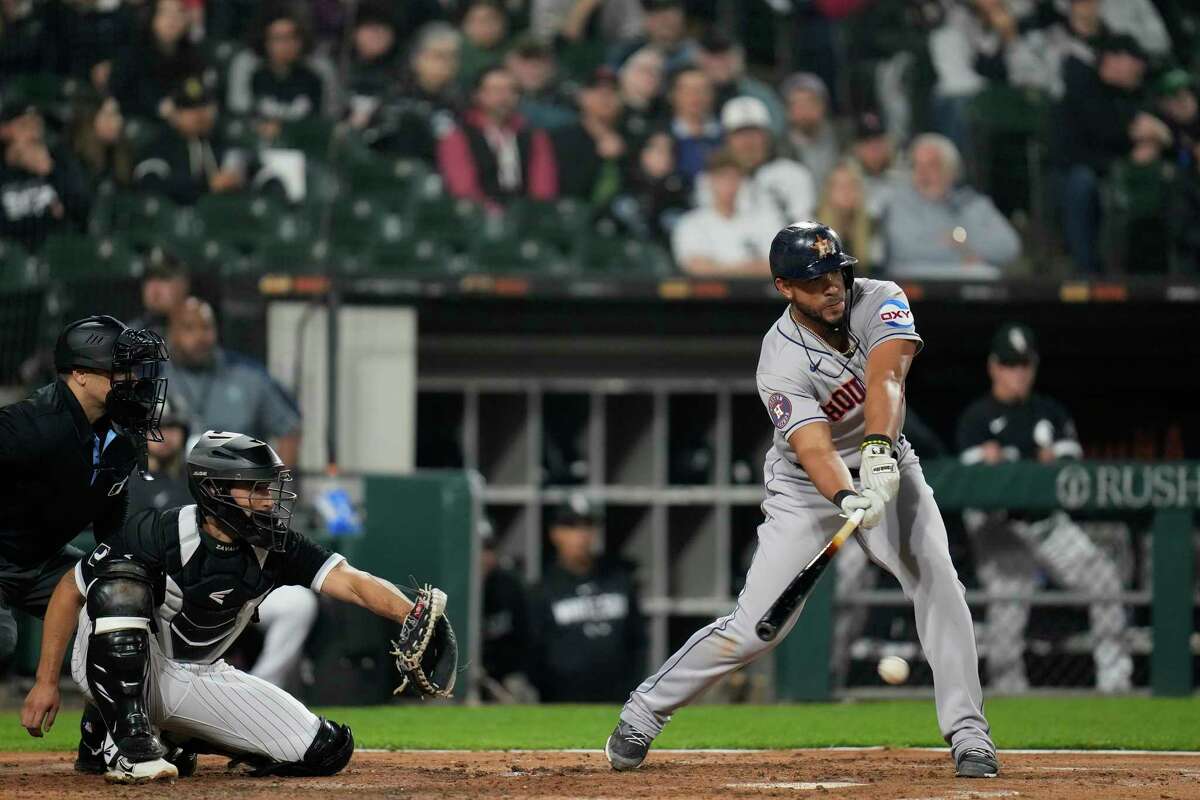 Houston Astros' Jose Abreu, right, connects with the ball but grounds out during the fourth inning of a baseball game against the Chicago White Sox, Friday, May 12, 2023, in Chicago.