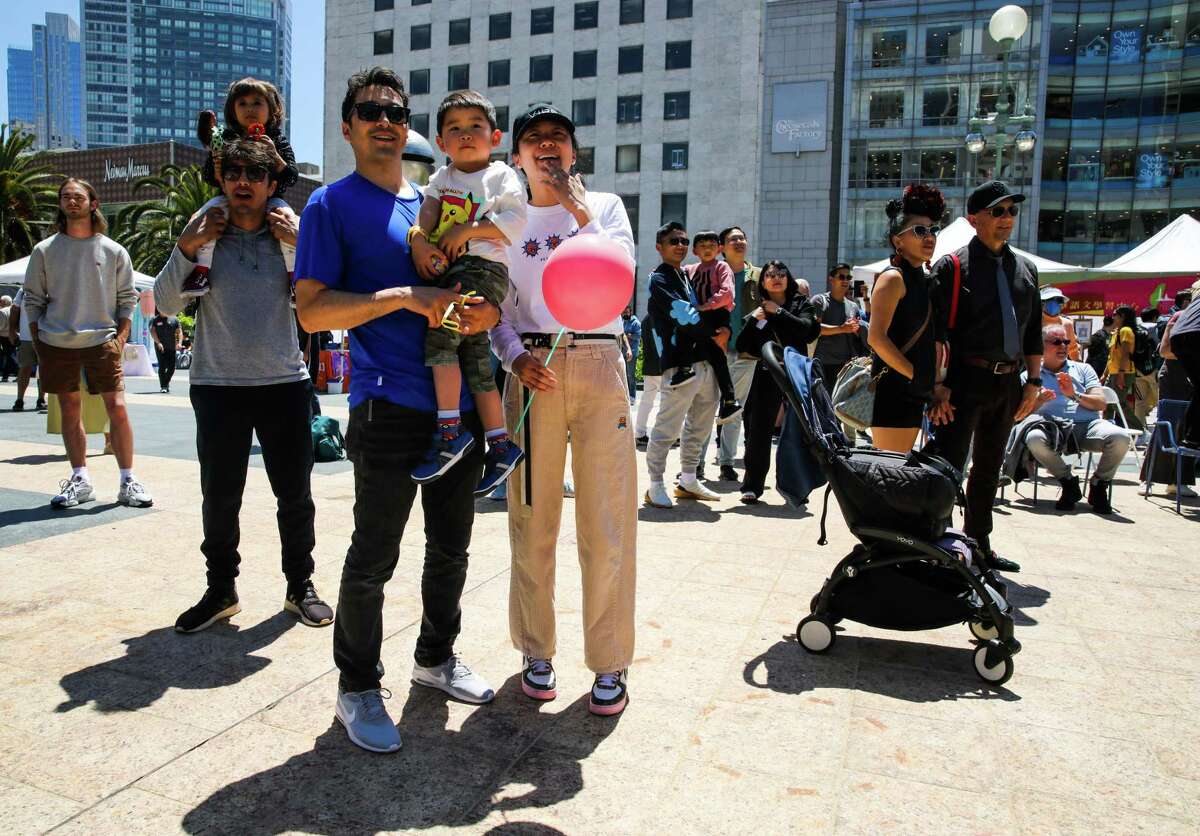 Left to right: San Francisco resident Brian Athos, his partner Mango Huang, and son Everett (3 years old) held Saturday, May 13, 2023 at Union Square in San Francisco, California. The event has become the largest celebration of Taiwanese-American culture on the West Coast.