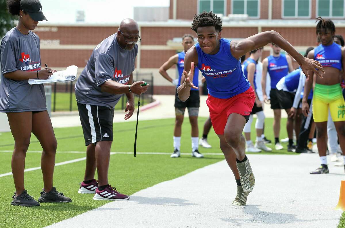Players go through drills Saturday during Chandler Rivers' youth football camp Saturday at Beaumont ISD Memorial Stadium.