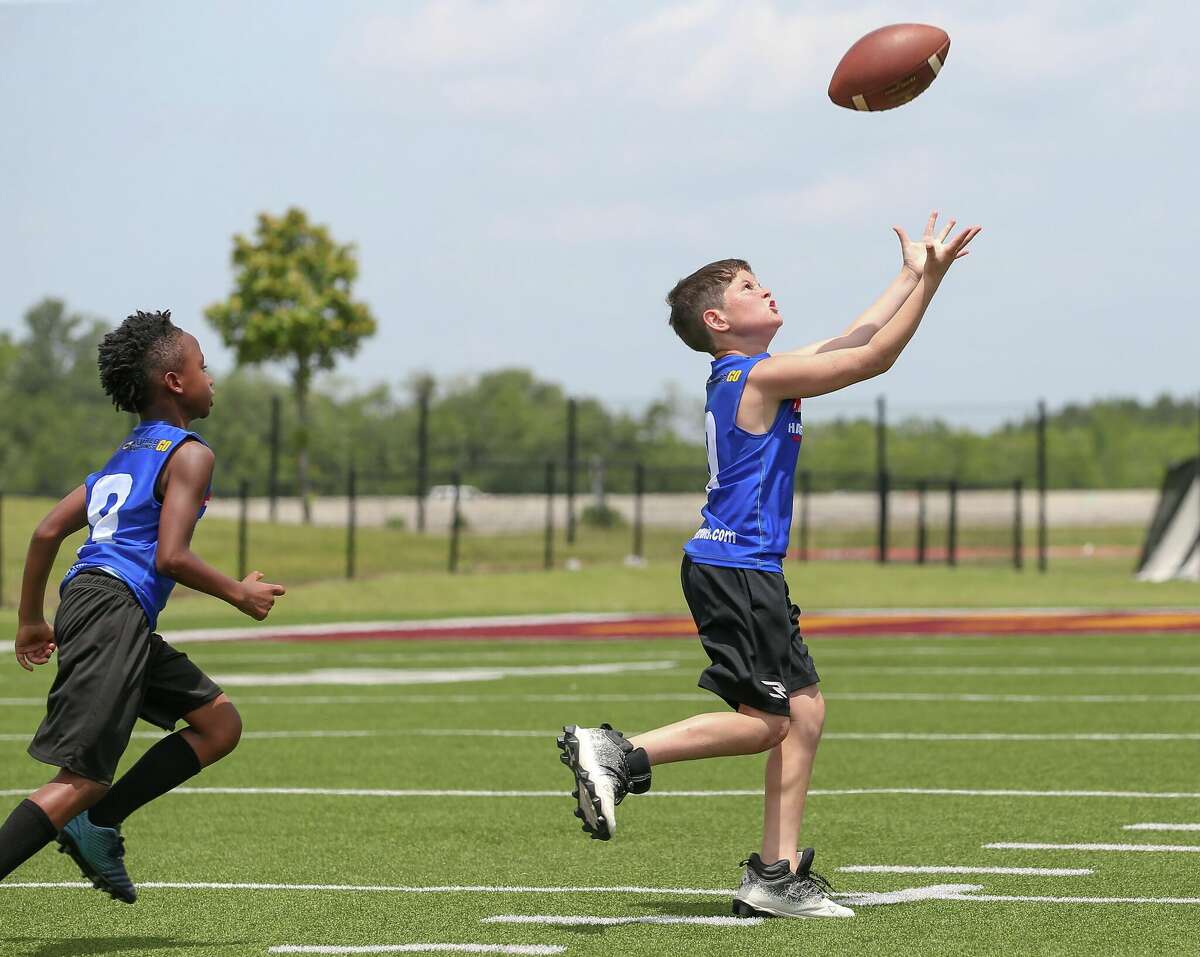 Players go through drills Saturday during Chandler Rivers' youth football camp at Beaumont ISD Memorial Stadium