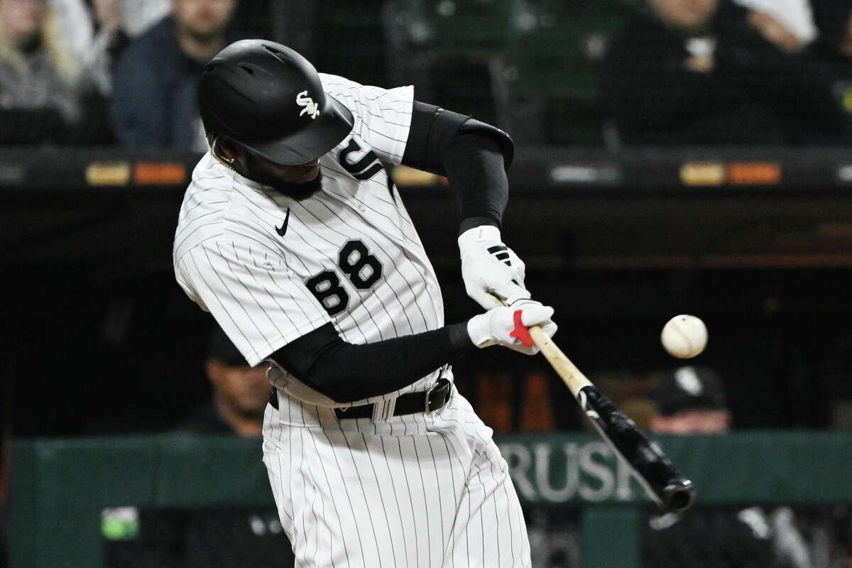 Luis Robert Jr. #88 of the Chicago White Sox reacts after hitting