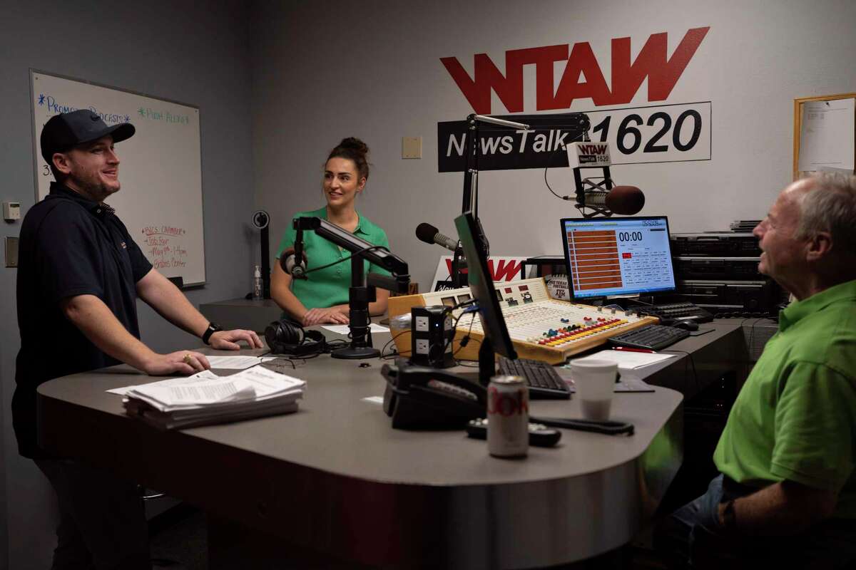 Sportscaster Sean Burnett, reporter Chelsea Reber and host Scott DeLucia gather to discuss their notes before WTAW's morning show "The Infomaniacs" airs.