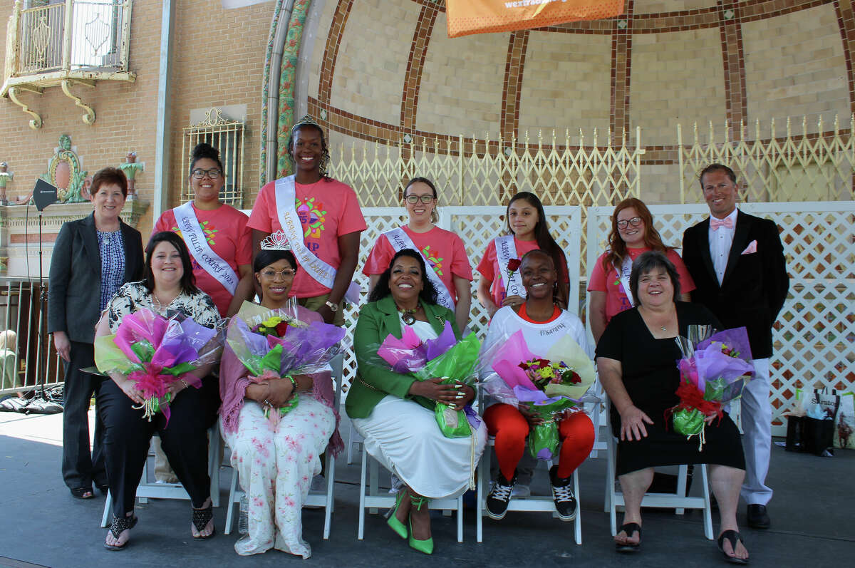 The Tulip Queen, Olivia Owens, and her Tulip Court stand behind Capital Region Best Mom of the Year, Leah Reed, second from left, front row, and the other Best Mom finalists. They pose for pictures with Albany Mayor Kathy Sheehan, back row left, and Chad O'Hara, back row right, of B95.5-FM on Sunday, May 14, 2023, in Washington Park in Albany, N.Y.