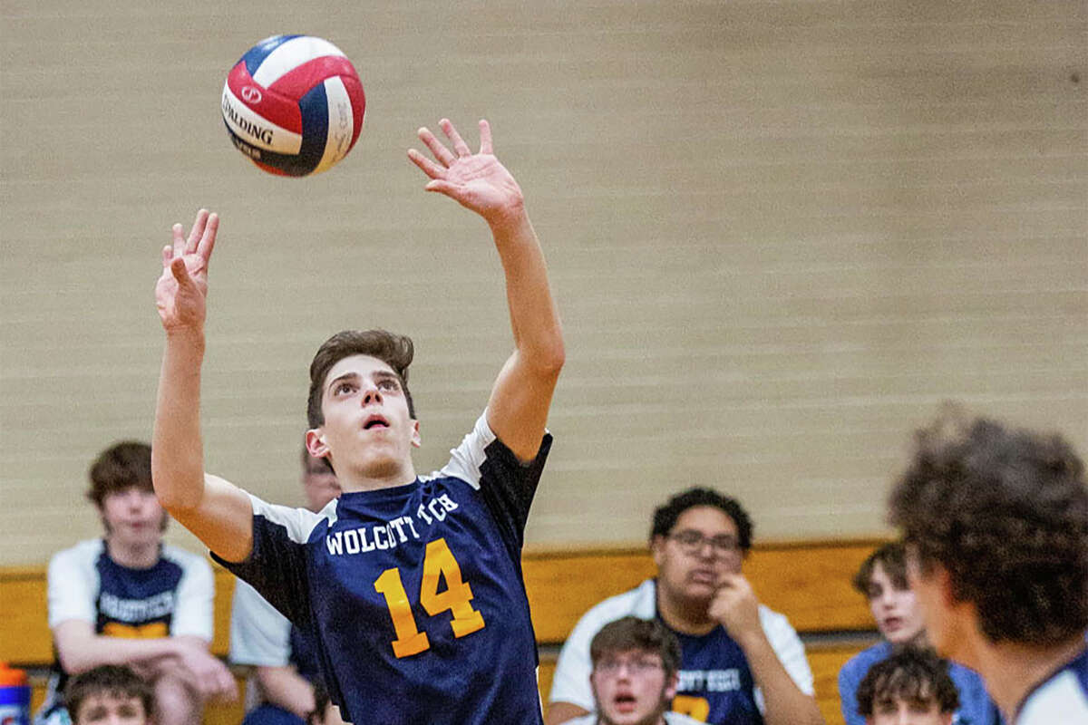 Matthew Hand of the Wolcott Tech boys volleyball team sets the ball during a match in the 2023 season.