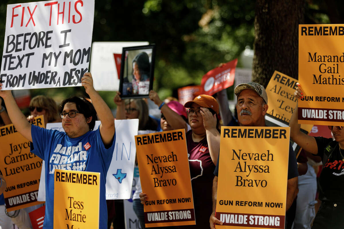 Diego Ortiz, left, Joe Martinez, right, and others attend the Raise Our Voices to Raise the Age March for Our Lives Rally at the Texas State Capitol in Austin, Texas, Saturday, Aug. 27, 2022. March For Our Lives, a youth-led gun control group, hosted the rally with Uvalde and Santa Fe parents to demand that Governor Abbott moves immediately to call a special session and raise the minimum age to purchase an AR-15 from 18 to 21.