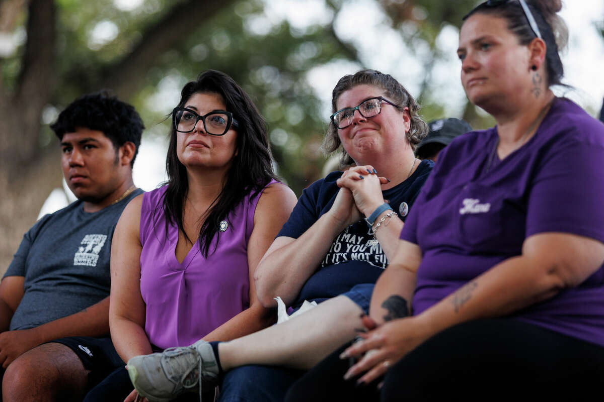 Christina Delgado, center left, and Rhonda Hart, center right, of Santa Fe react as they listen to Javier Jacinto Cazares during a Get Out the Vote rally at the Town Square in Uvalde, Texas, Saturday, Oct. 8, 2022. Hart lost her daughter Kimberly Vaughan in the May 2018 shooting that killed 10 people at Santa Fe High School.