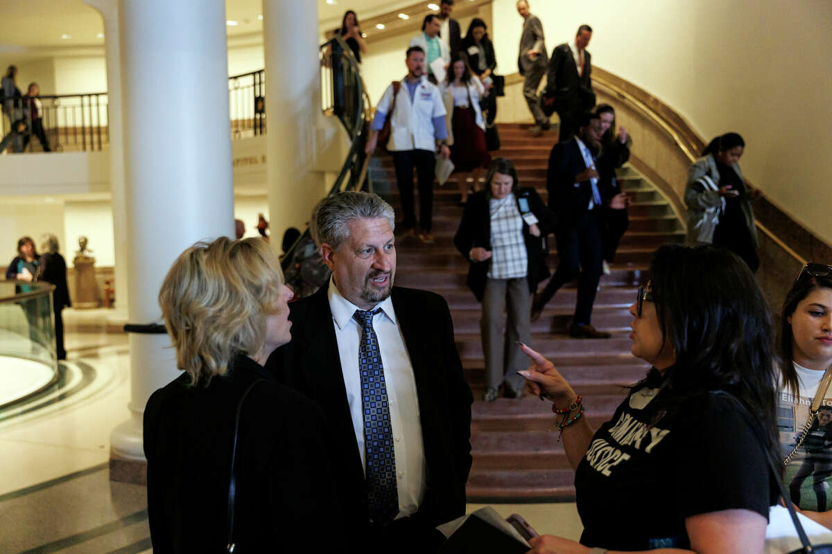 Flo, from left, and Scot Rice talk with Christina Delgado during an End Gun Violence Advocacy Day at the Capitol in Austin, Tuesday, Feb. 28, 2023. Flo survived the 2018 mass shooting at Santa Fe High School, where she worked as a substitute teacher and was shot six times in the legs.