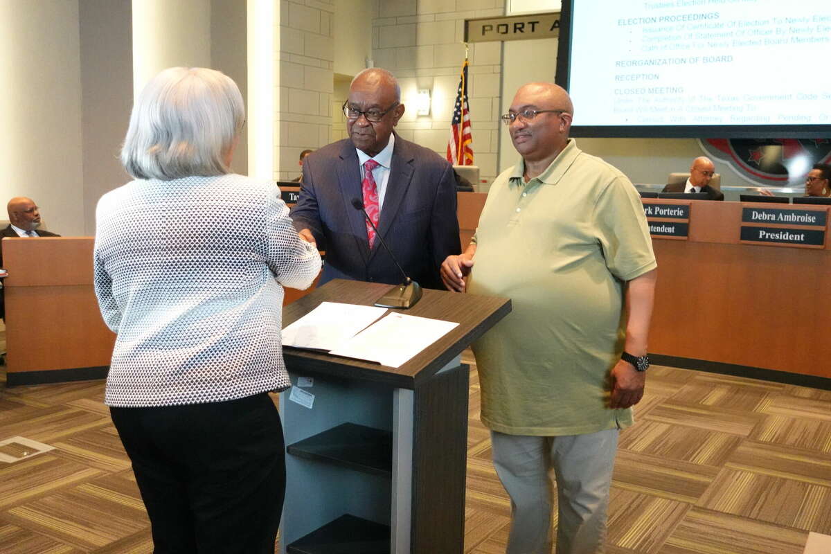 Port Arthur ISD attorney Melody Carrier, left, administers the oath of office to former district Superintendent Johnny Brown, center, and Kenneth Lofton, Sr., right, for their new terms as school board trustees. Photo taken May 16, 2023. Photo by Olivia Malick/ The Enterprise.