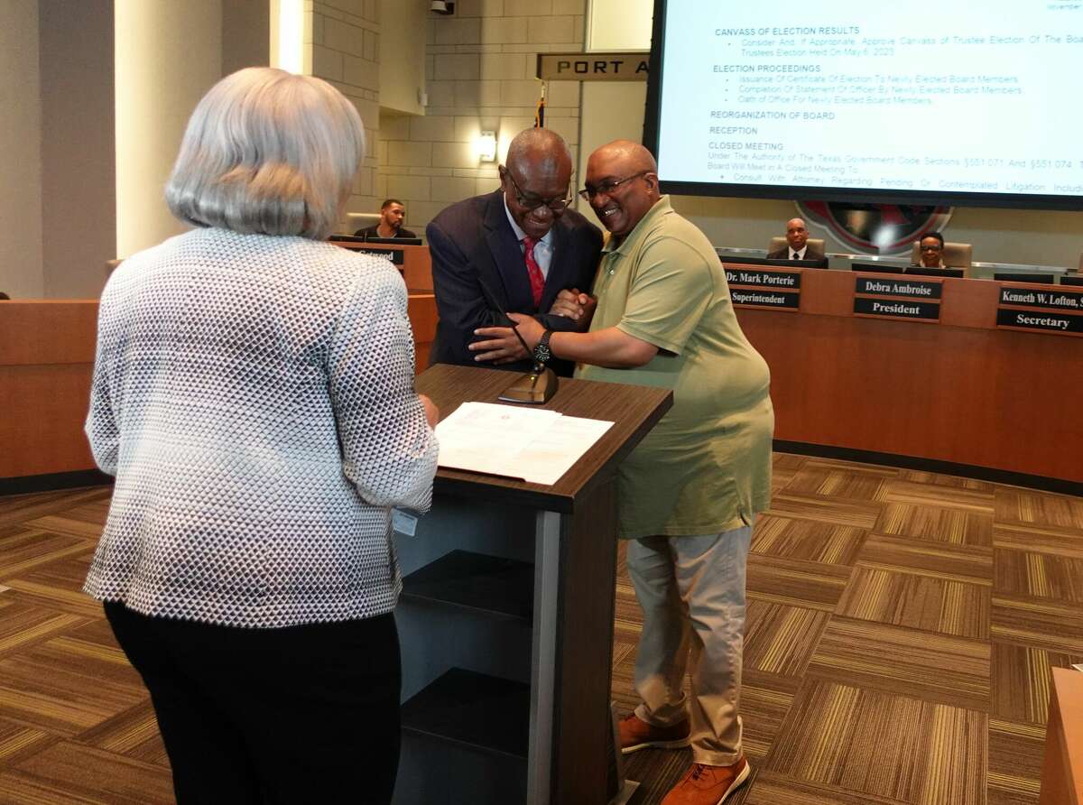 Incoming Port Arthur ISD school board members Johnny Brown, center, and Kenneth Lofton, Sr., right, congratulate each other on their election to the school board before being sworn in by school district attorney Melody Carrier, left. Photo taken May 16, 2023. Photo by Olivia Malick/ The Enterprise