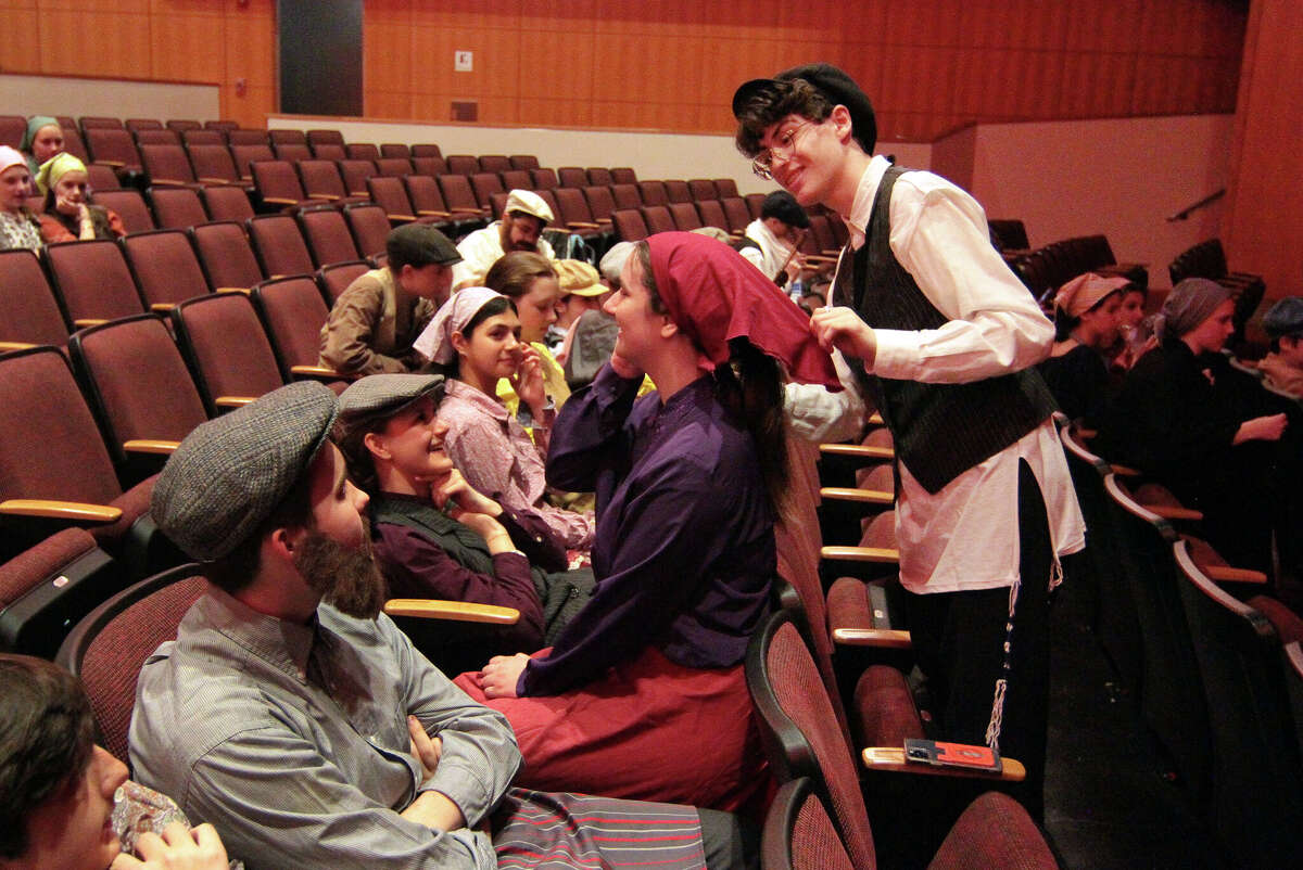 Chris Messis helps Kyle Roy put on his costumes during dress rehearsal of Fiddler on the Roof at the school in Greenwich, Connecticut on Tuesday, May 16, 2023. Performances are on May 18, 19 and 20 at 7 p.m instead of GHS Performing Arts Center.