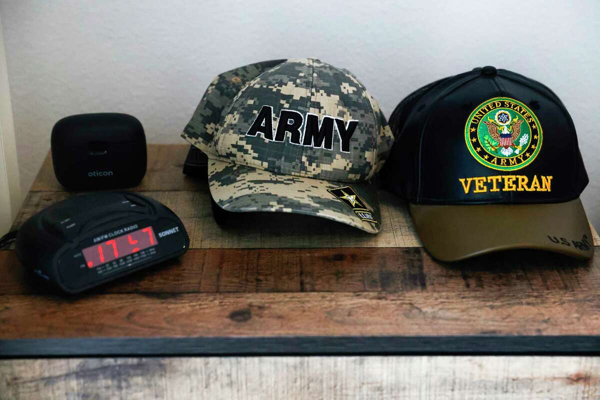 Hats lie on the bedside table of U.S. Army veteran James Kauffman, 62, at his apartment in the newly constructed Maceo May Veterans Residence complex on Treasure Island in San Francisco, Tuesday, May 16, 2023.