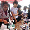 X'Zyriah Oville digs in as she makes fluffy slime at the BASF "Kids Lab" station during the STEM activity event at Abraham Lincoln Middle School Wednesday. Photo made Wednesday, May 17, 2023 Kim Brent/Beaumont Enterprise