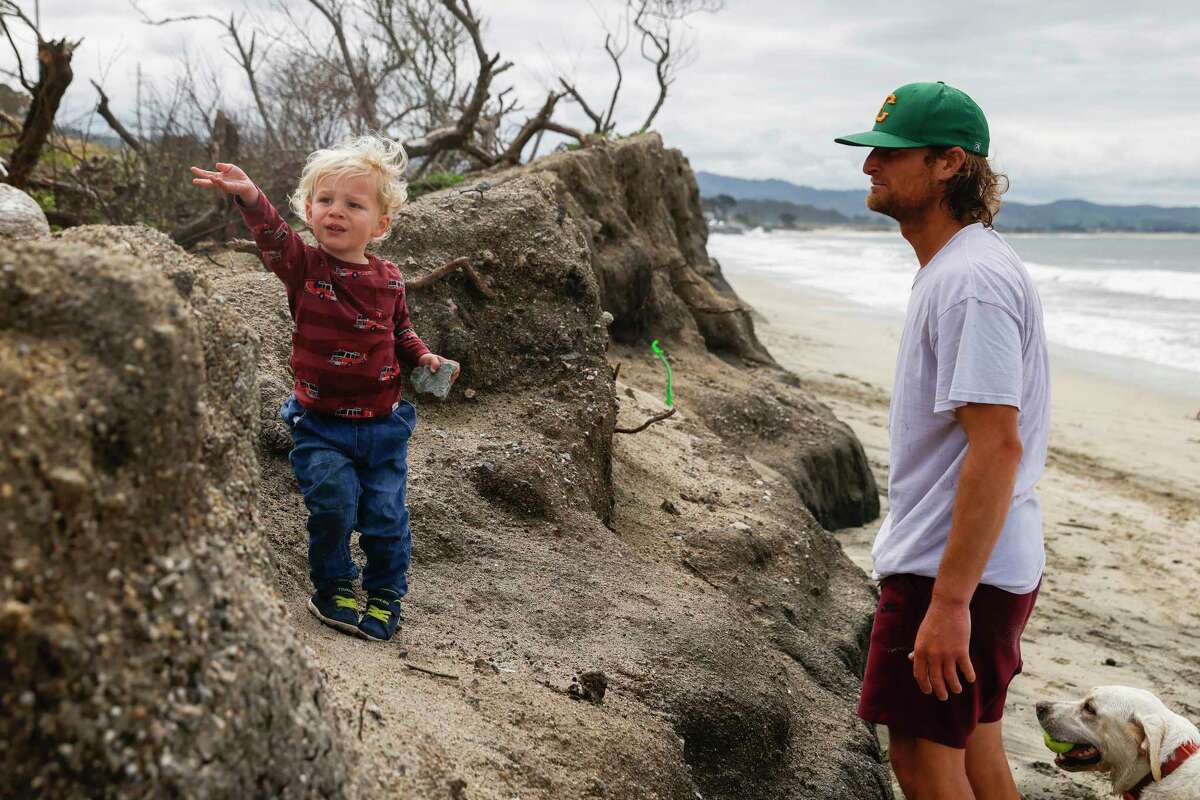 Liam Nerenberg, 2, climbs down an eroded cliff to his father Devin Nerenberg at Surfer’s Beach in Half Moon Bay, Calif. Friday, May 5, 2023. 25% to 70% of California?s beaches may erode completely by 2100, according to new research from US Geological Survey.