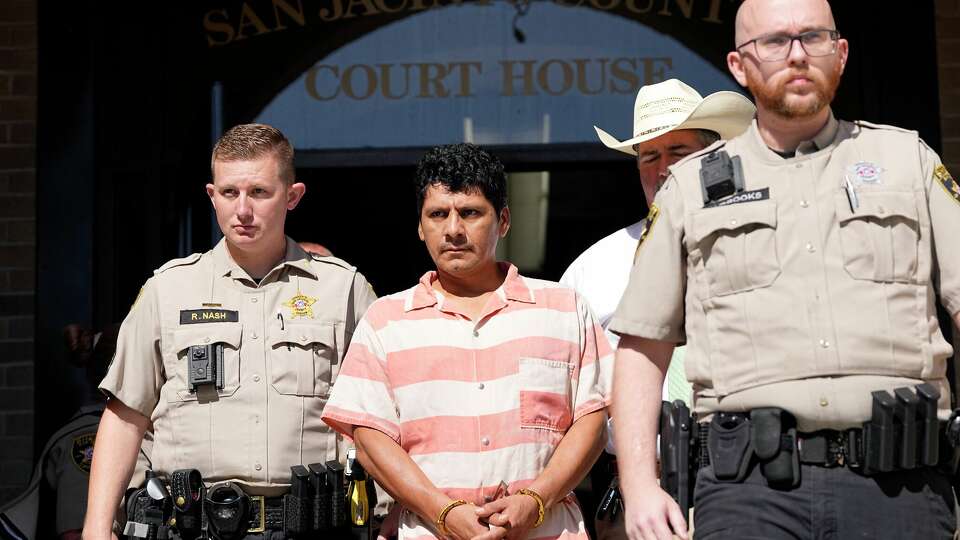 Francisco Oropeza is escorted from the San Jacinto County courthouse after a hearing Thursday, May 18, 2023, in Coldspring, Texas. Oropeza is suspected of killing five people, including a 9-year-old boy, after neighbors asked him to stop firing off rounds in his yard. (AP Photo/David J. Phillip)