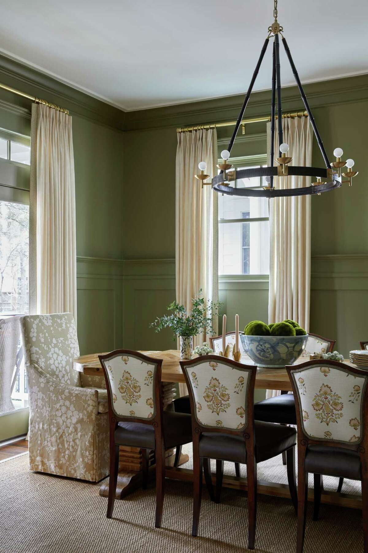 The dining room in the main home has new draperies, chandelier, chairs and paint.