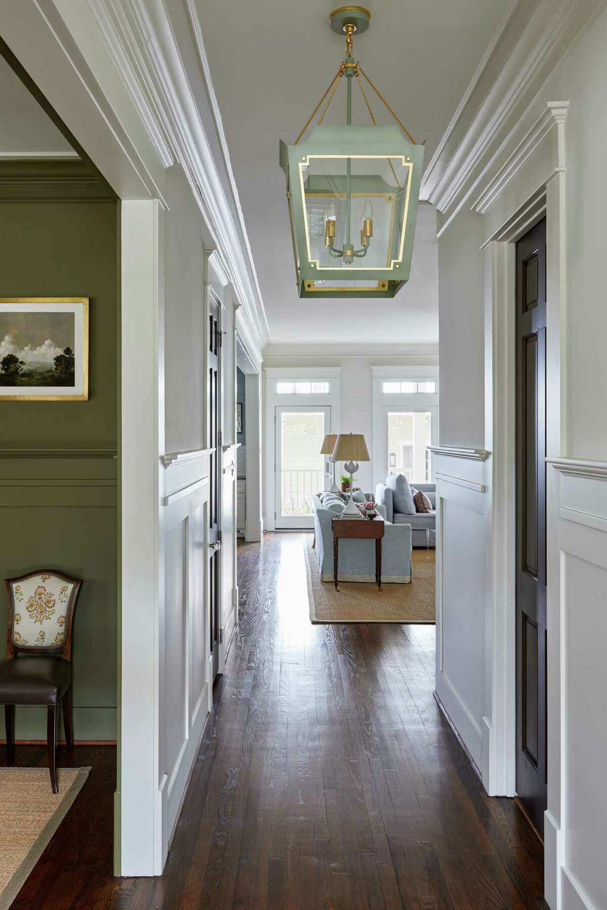 New lantern pendants decorate the hallway in the front of the Ackals' main home.