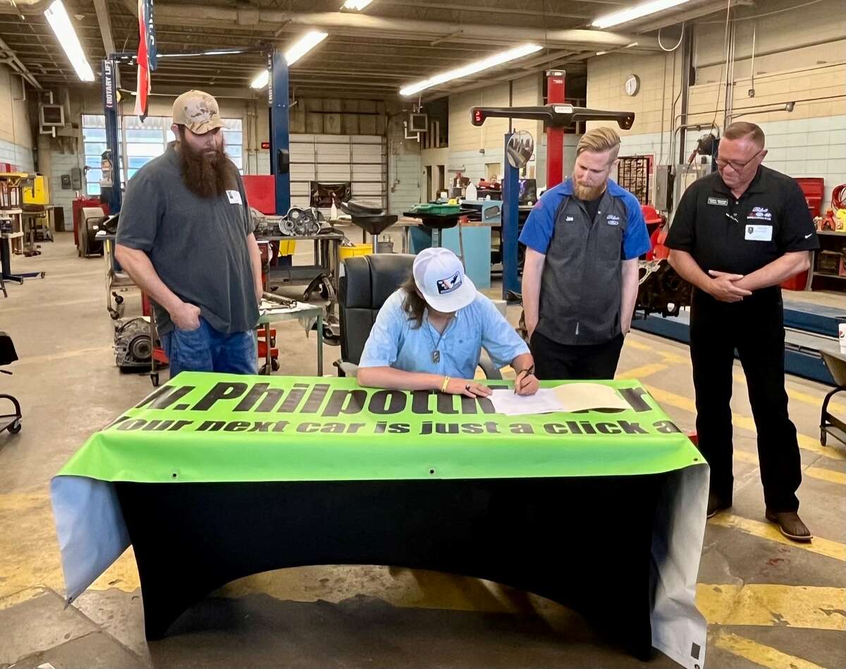 Nederland High School senior Tanner Garcia signs a letter of intent to work for Philpott Motors after graduation, May 17, 2023.
